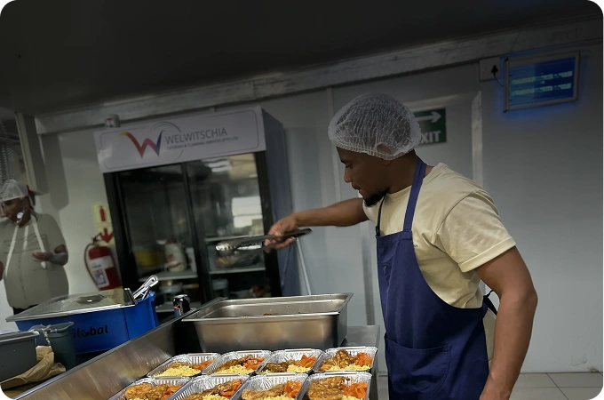 WCCS catering team member preparing meals